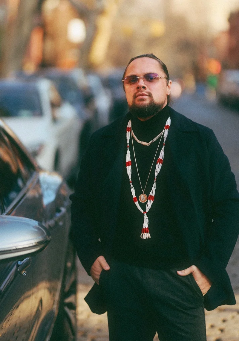Mark Pugachev standing beside a vehicle on a city street